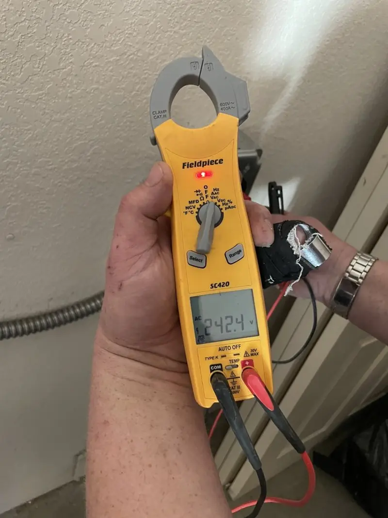 Voltage testing with clamp meter during Whole House Surge Protector in East Donegal